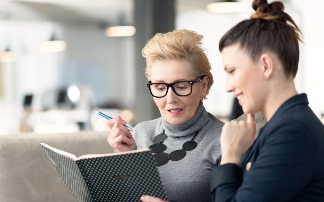 franchising consultant and an entrepreneur going through notes